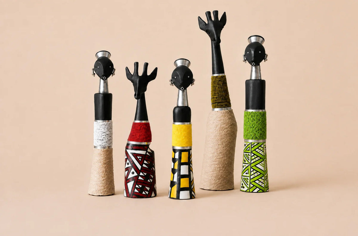 A collection of wood carved African curios with beaded decor designs.