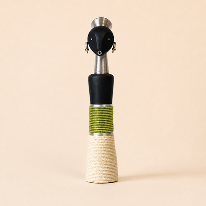 African carved doll with a green and beige design on a beige background