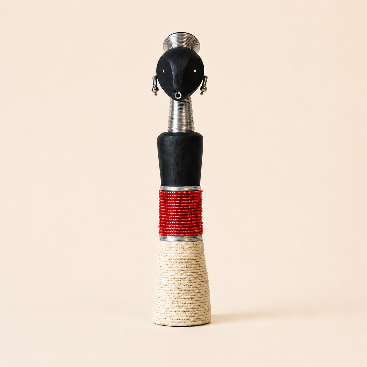 Decorative object with black, red, and beige design on a beige background