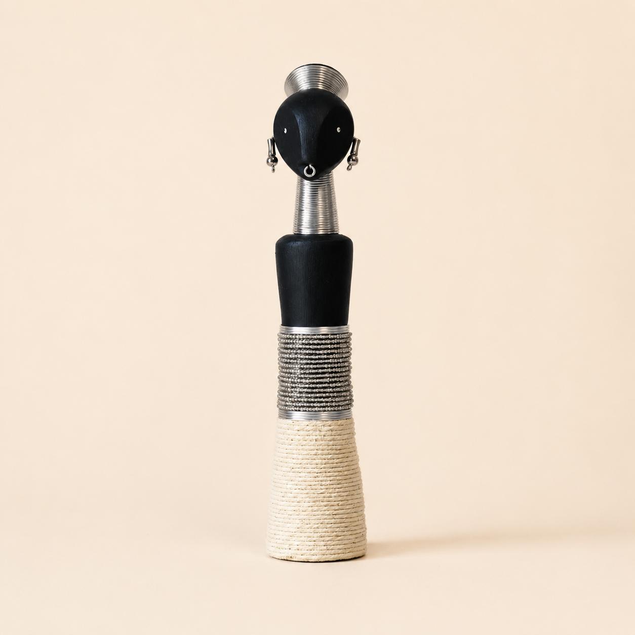Decorative carved wooden doll with white glass beads and rope on a beige background