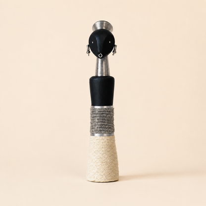 Decorative carved wooden doll with white glass beads and rope on a beige background