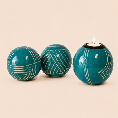 Carved and coloured Monkey Balls and Tlite turquoise and set on a beige background