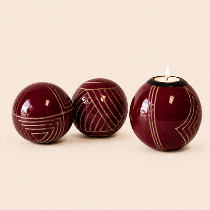 Carved and coloured Monkey Balls and Tlite in burgundy and set on a beige background