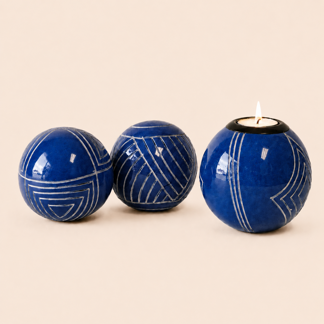 Carved and coloured Monkey Balls and Tlite in blue and set on a beige background