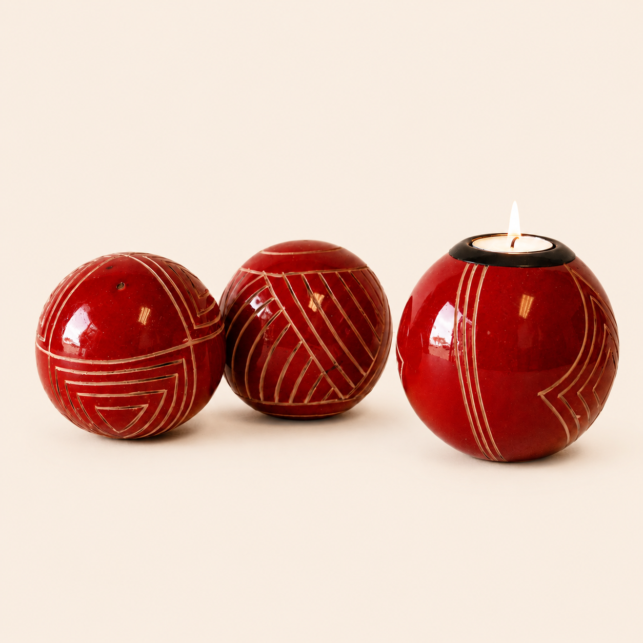 Carved and coloured Monkey Balls and Tlite in red and set on a beige background