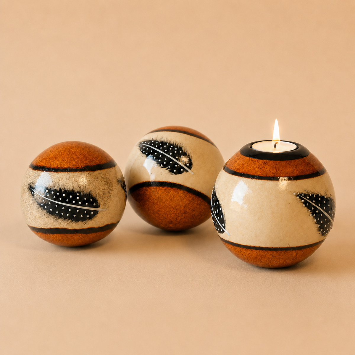 Coloured Feather Monkey Balls & Tlite in Orange on a beige background