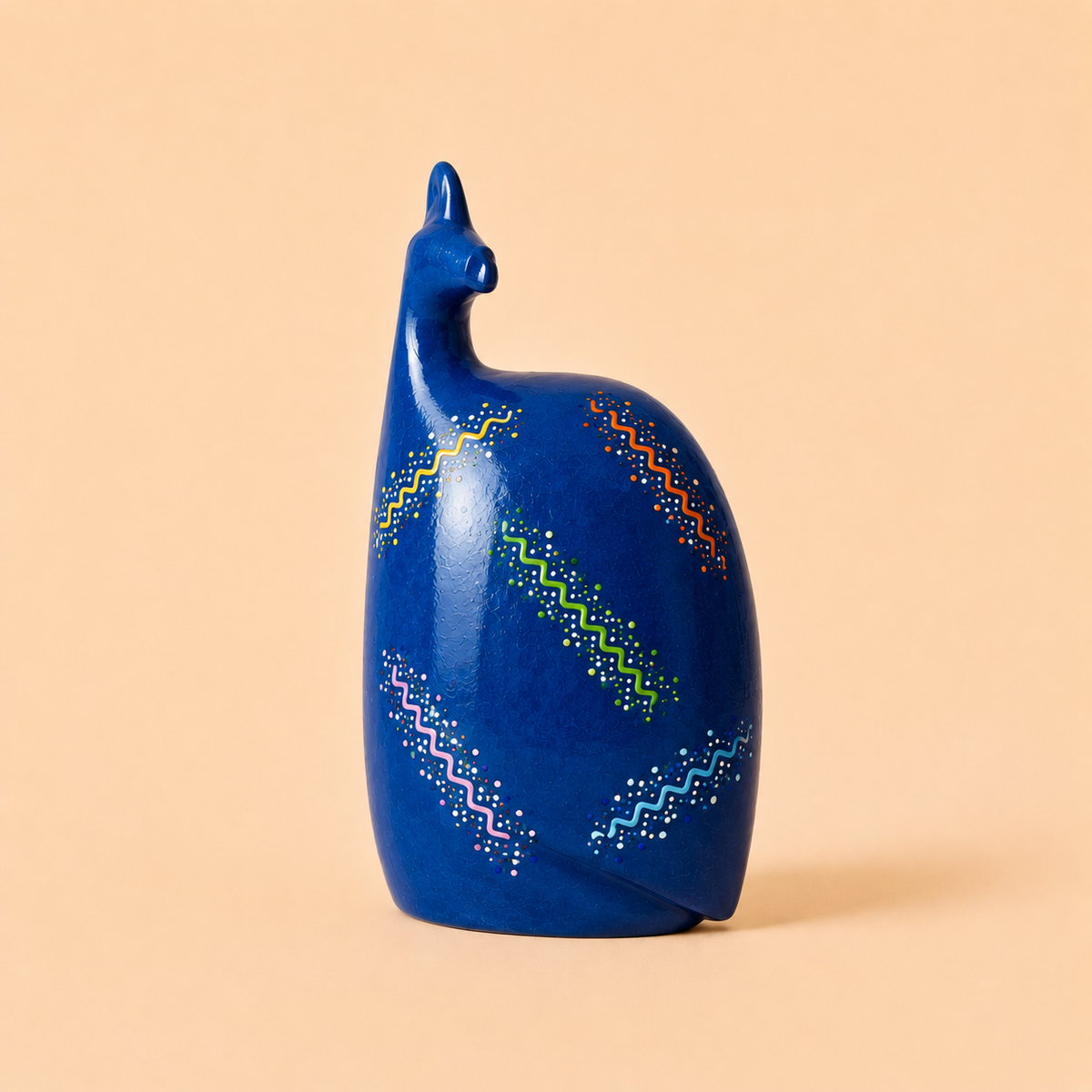 Hand painted Ethnic Guinea-fowl carving in blue on a beige background