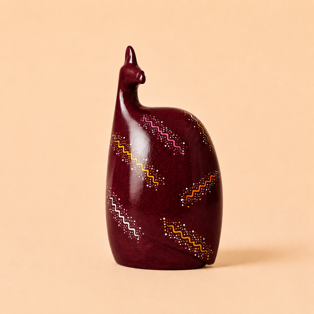 Hand painted Ethnic Guinea-fowl carving in burgundy on a beige background