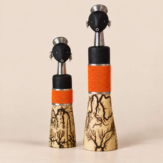 Wooden figurine with orange beads and a lightning base on a blank background