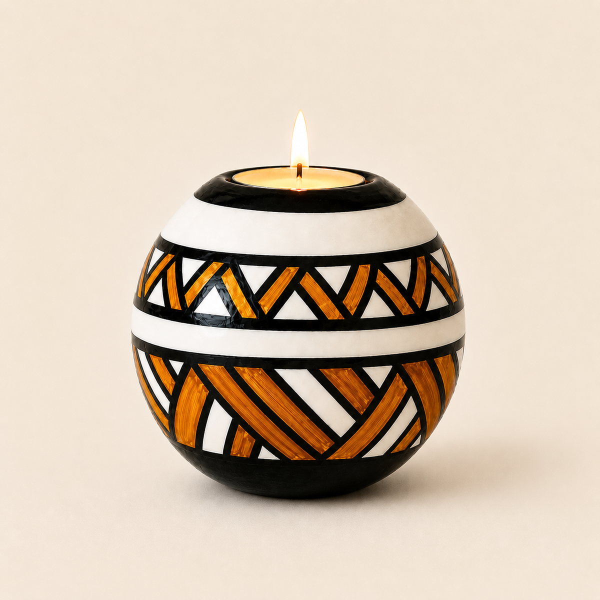 Monkey Ball T-lite with Orange Ndebele patterns on a beige background