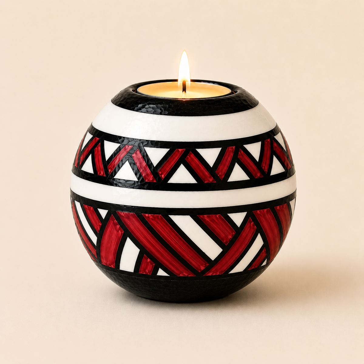 Monkey Ball T-lite with Red Ndebele patterns on a beige background