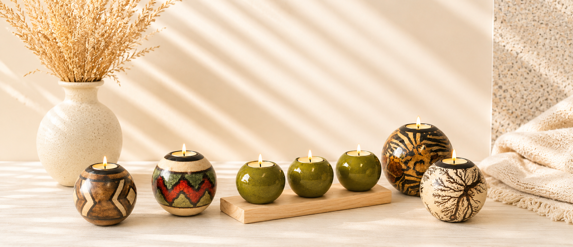 Decorative candles in unique holders on a wooden surface with a neutral background