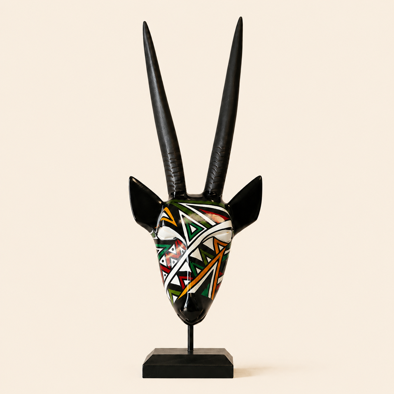 Ndebele Mono Antelope Head in a multicolour pattern carved from wood and set on a beige background
