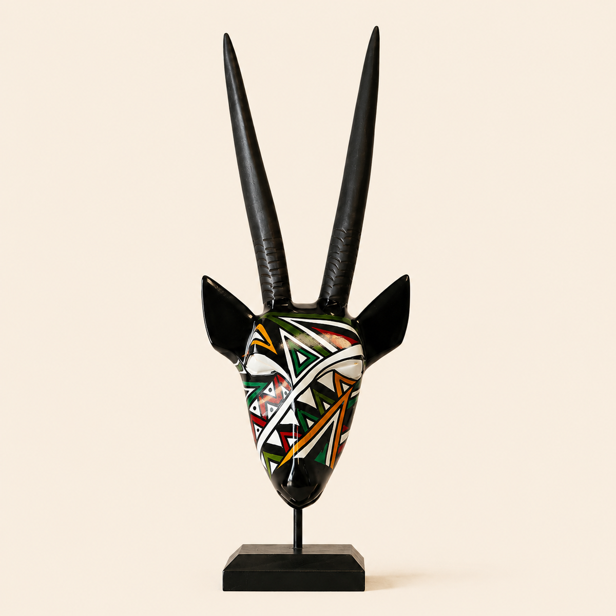 Ndebele Mono Antelope Head in a multicolour pattern carved from wood and set on a beige background
