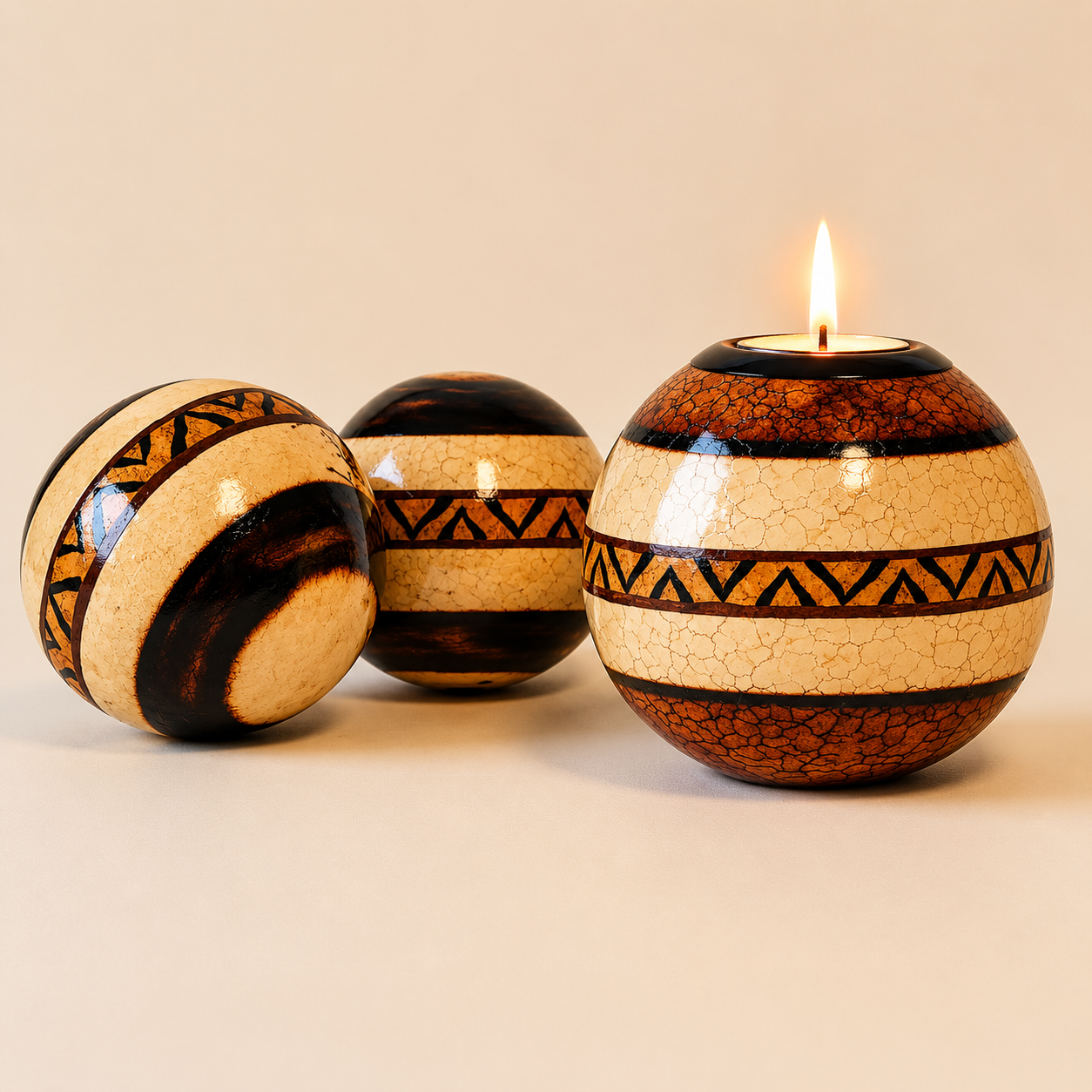 Round wooden monkey apples with burnt designs on the natural wood and rings of tribal designs on a beige background. These are offered as a round display or a T-lite option.