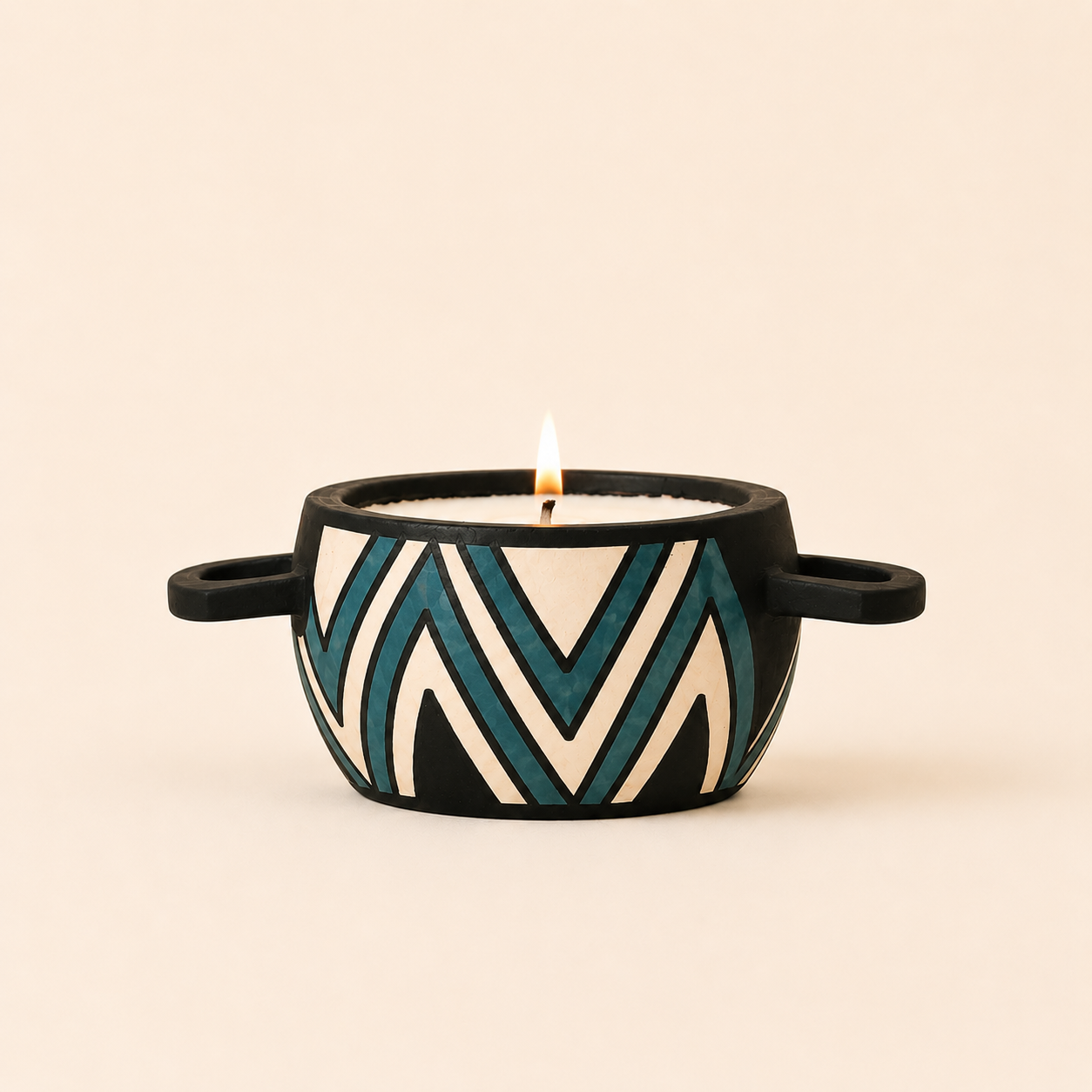 Wood carved pot filled with candle wax and decorated with a turquoise striped design.