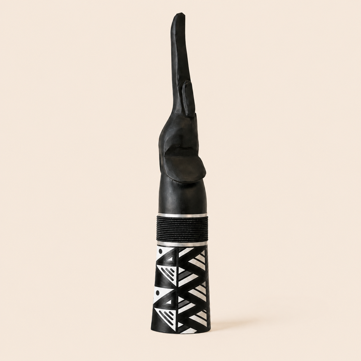 Black wood carved goodluck elephant with trunk up, black beads and mono ndebele patterns on the base.