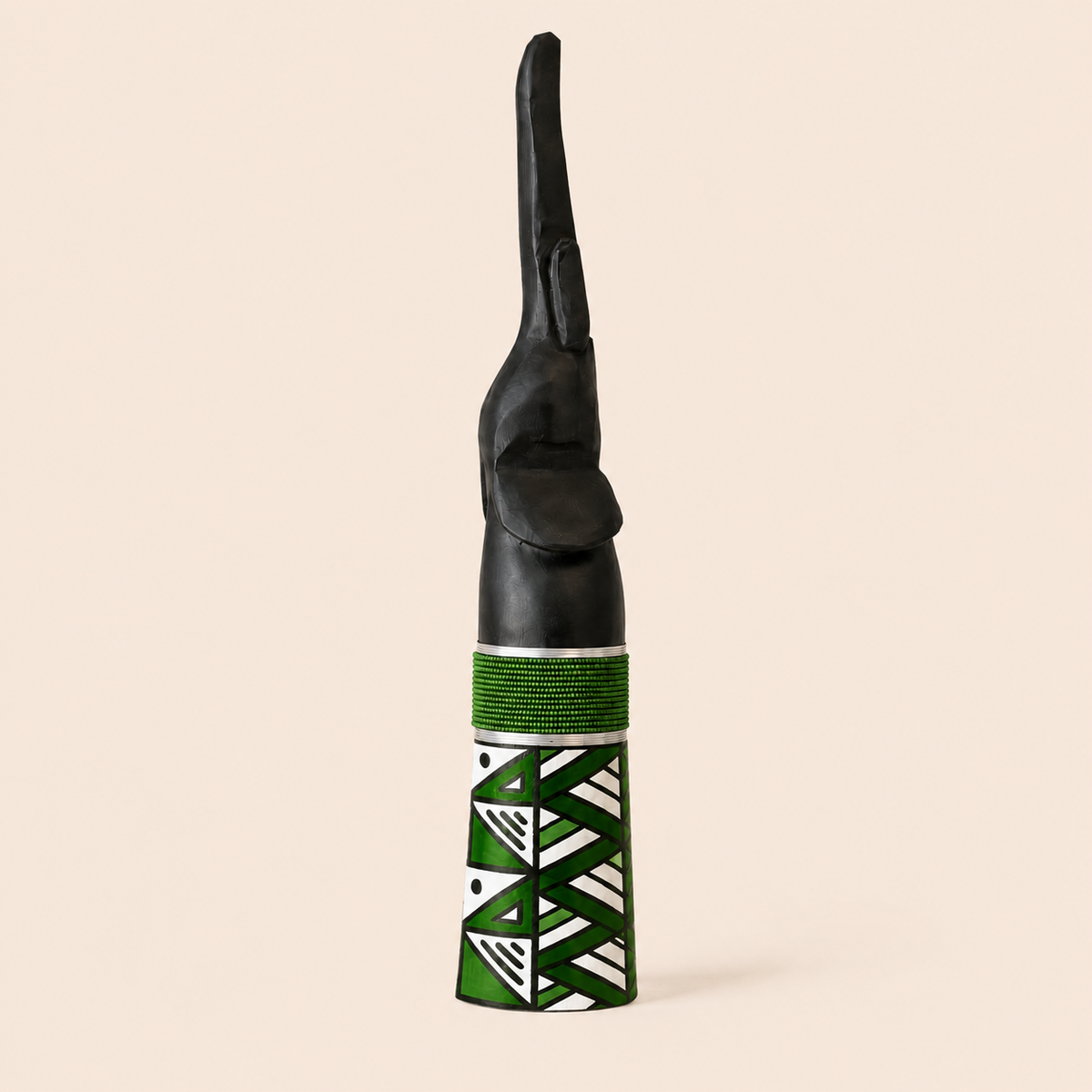 Wood carved elephant with green beads and a green Ndebele pattern on the base.