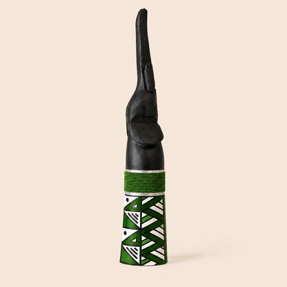 Wood carved elephant with green beads and a green Ndebele pattern on the base.