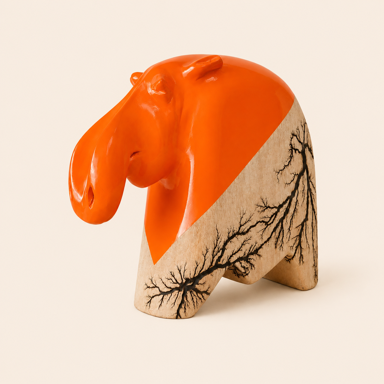 Decorative hippo head sculpture with orange and beige colors on a beige background