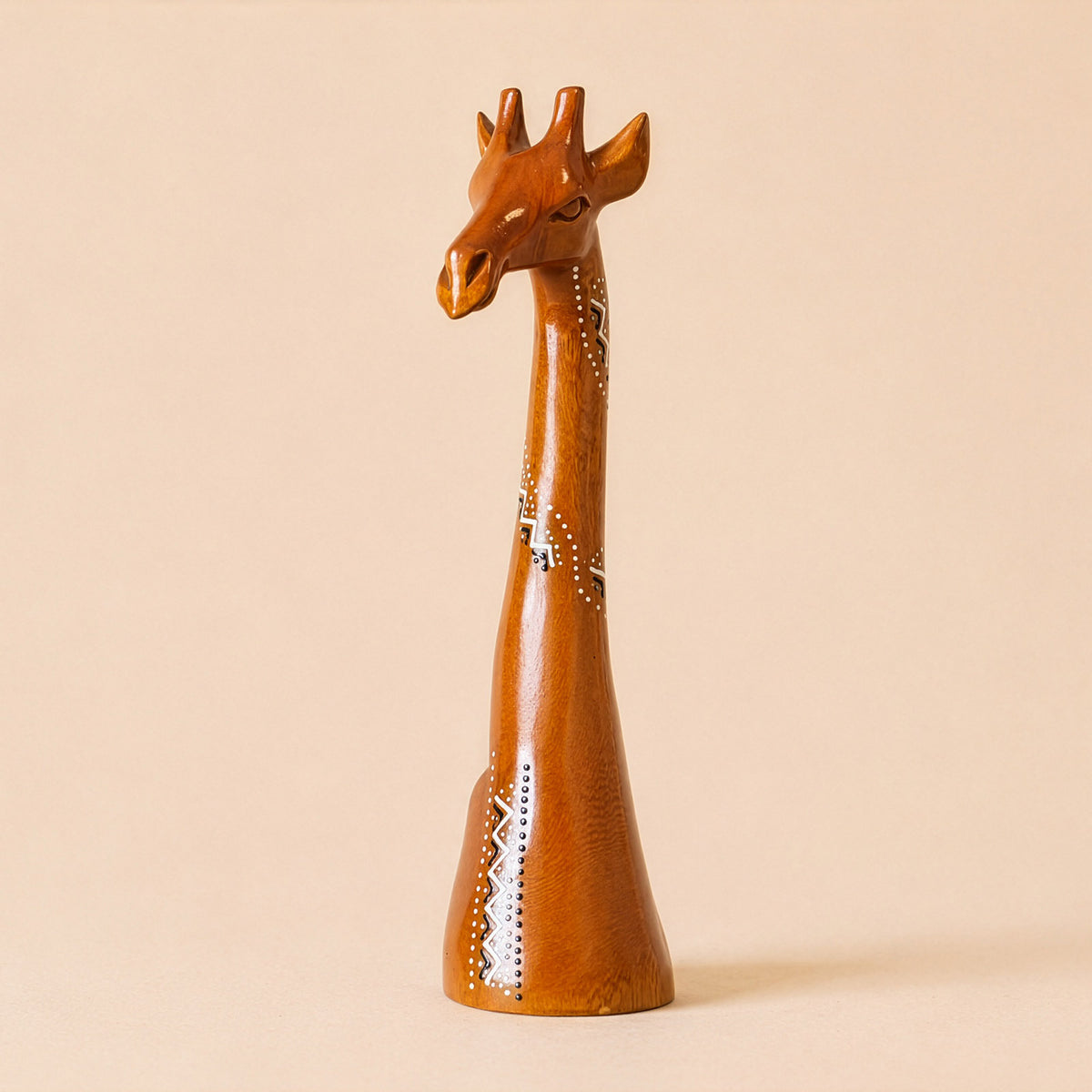 Wooden giraffe figurine on a beige background with ethnic patterns